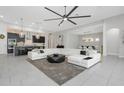 Spacious open-concept living area with modern decor and seamless access to the kitchen and dining spaces at 4287 Woodland Retreat Blvd, New Port Richey, FL 34655