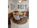 Cozy dining area with a round table, comfortable seating, and natural light at 6050 Chesham Dr # 3, New Port Richey, FL 34653