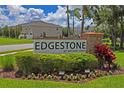 Attractive Edgestone at Artisan Lakes community sign with manicured landscaping, stone accents and flowering plants at 6240 Fairmont Ln, Palmetto, FL 34221