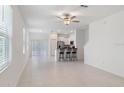 Bright and airy open-concept living space featuring large windows and sleek tile flooring at 8305 Crescent Oaks Dr, New Port Richey, FL 34655