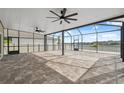 Large screened patio features ceiling fans and brick pavers, perfect for outdoor entertaining at 8938 Bower Bass Cir, Wesley Chapel, FL 33545