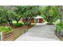 Long driveway leading to the home, enhanced by the mature trees and landscaping that surround the property at 9130 Madrid Rd, Weeki Wachee, FL 34613