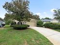 Inviting single-story house with a well-manicured lawn and mature trees at 10097 Holly Berry Dr, Weeki Wachee, FL 34613