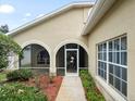 Charming front porch with decorative arches and a secure screen door at 10097 Holly Berry Dr, Weeki Wachee, FL 34613