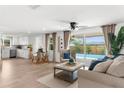 Bright and inviting open floor plan living room with pool views, dining area, and modern decor at 10224 Old Orchard Ln, Port Richey, FL 34668