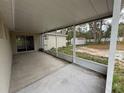 Covered patio provides a comfortable outdoor living space overlooking the backyard at 11308 Mahopac Rd, Weeki Wachee, FL 34614