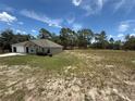 Spacious property featuring a well-maintained lawn, attached garage and generous open land with a house at 11308 Mahopac Rd, Weeki Wachee, FL 34614