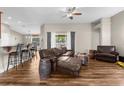 Open-concept living room with hardwood floors, stylish furniture, and views of the backyard at 12026 Penguin Ave, Weeki Wachee, FL 34614