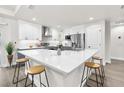 Bright kitchen featuring quartz countertops, stainless steel appliances, modern cabinets, and a spacious island with seating at 12420 Talpa St, Spring Hill, FL 34608