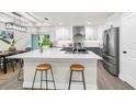 Modern kitchen with stainless steel appliances, a spacious quartz countertop island, and stylish two-tone cabinetry at 12420 Talpa St, Spring Hill, FL 34608