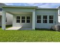 A covered patio off the rear of the house provides the perfect space to enjoy the backyard at 14437 Maiden Ter, Lakewood Ranch, FL 34211