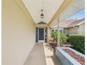 Inviting front porch with tile flooring, decorative plants, and a sheltered entrance to the home at 14646 Coronado Dr, Spring Hill, FL 34609