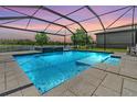 Stunning screened-in pool area with a lake view, perfect for outdoor relaxation and entertaining at 1783 Oak Hammock Ct, Lutz, FL 33558