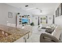 Open-concept living room with a modern entertainment center, stylish furniture, and a cozy atmosphere at 18530 Dobson Dr, Hudson, FL 34667