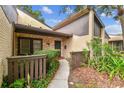 Charming front entrance with a stone accent wall and well-maintained landscaping at 2101 Sunset Point Rd # 201, Clearwater, FL 33765