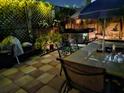 Outdoor dining area featuring a hot tub, dining table, and decorative lighting for evening enjoyment at 21045 Lazy Days Cir, Lutz, FL 33558