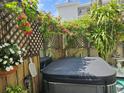 Outdoor hot tub with lush flowering vines creating a private, tropical oasis at 21045 Lazy Days Cir, Lutz, FL 33558