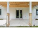 Covered porch featuring a wood ceiling and white support columns at 2288 Rackley Rd, Brooksville, FL 34604