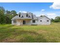 Charming white home featuring a covered front porch and a well-maintained lawn at 2288 Rackley Rd, Brooksville, FL 34604