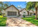 Charming single-story home featuring a well-manicured lawn, two-car garage and covered carport at 2342 Countryside Dr, Spring Hill, FL 34606