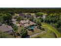 Aerial view of house with pool, pond, golf course, and other community amenities nearby at 2987 Wentworth Way, Tarpon Springs, FL 34688
