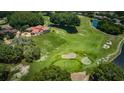 Aerial view of a home located on a golf course and pond at 2987 Wentworth Way, Tarpon Springs, FL 34688