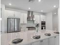 Modern kitchen with stainless steel appliances, gas range, granite countertops and large island at 33466 Landsman Loop, Wesley Chapel, FL 33543
