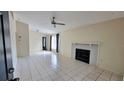 Spacious living room with tile flooring, a ceiling fan, fireplace, and a window for natural light at 4015 Angel Oak Ct # 201, Tampa, FL 33613