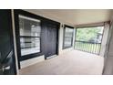 Condo porch view with an enclosed patio space featuring black railings, a large window, and painted trim at 4015 Angel Oak Ct # 201, Tampa, FL 33613