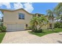 Spacious home with a two-car garage, stone driveway, and mature landscaping at 4052 Marine Pkwy, New Port Richey, FL 34652