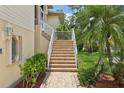 Close-up of the home's exterior highlighting stone steps and lush landscaping at 4052 Marine Pkwy, New Port Richey, FL 34652