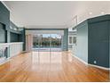 Bright living room featuring hardwood floors, a fireplace, and a view of the pool at 4351 Mallard Lake Dr, Spring Hill, FL 34609