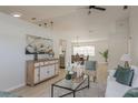 Bright living room seamlessly connects to the dining area with modern decor and ample natural light at 4752 Weasel Dr, New Port Richey, FL 34653