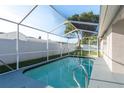 Screened-in private pool offers a refreshing escape with a spacious deck for relaxation and entertaining at 4752 Weasel Dr, New Port Richey, FL 34653