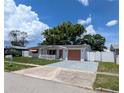 Delightful single story home featuring a white picket fence, colorful details, and well-kept landscaping at 4853 Alcea St, New Port Richey, FL 34652