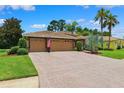 Beautiful home with a spacious brick driveway leading to a two-car garage at 5121 Delacroix Dr, Brooksville, FL 34604