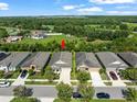 Aerial view of a single story home with lush backyard, mature trees and well-kept lawn at 6130 Colmar Pl, Apollo Beach, FL 33572