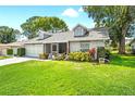 Charming single-story home with a well-manicured lawn and inviting front entrance at 6282 Darien Way, Spring Hill, FL 34606