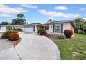 Charming home with a well-manicured lawn and inviting driveway and attached two car garage at 7133 Box Elder Dr, Port Richey, FL 34668