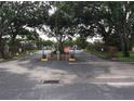 Gated entrance to the community, enhancing security and privacy for residents and guests with mature trees in the surrounding landscape at 7614 Radcliffe Cir # B213, Port Richey, FL 34668