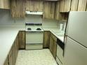 Functional kitchen with appliances, countertops, and cabinetry, ready for your personalization and culinary adventures at 7614 Radcliffe Cir # B213, Port Richey, FL 34668