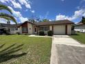 Charming single-story home featuring a well-manicured lawn and attached garage at 8312 Split Rail Ln, Hudson, FL 34667