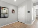 Home foyer featuring light gray walls, wood flooring, and a modern keypad at 8457 Southern Charm Cir, Brooksville, FL 34613