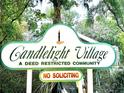 Candlelight Village community sign indicates deed restricted community with a no soliciting policy at 952 Coachlight Ln, Brooksville, FL 34601