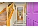 Inviting foyer featuring a wooden staircase and views into the naturally lit living spaces at 952 Coachlight Ln, Brooksville, FL 34601