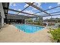 Relaxing screened-in pool with canal view and plenty of room for entertaining outdoors at 9921 San Mateo Way, Port Richey, FL 34668