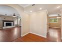 Open entryway with wood floors, arched doorway, and fireplace view at 10091 Bannister St, Spring Hill, FL 34608