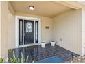 Inviting front porch with decorative tile flooring and space for potted plants at 10091 Bannister St, Spring Hill, FL 34608