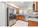 Kitchen boasts stainless steel appliances, granite countertops, tile backsplash, and ample storage at 10115 Ringling St, New Port Richey, FL 34655