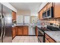 Well-equipped kitchen featuring stainless steel appliances, granite countertops, and ample cabinet space at 10115 Ringling St, New Port Richey, FL 34655